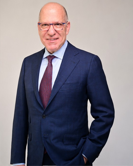 On-location corporate headshot of a man in a navy suit, NYC