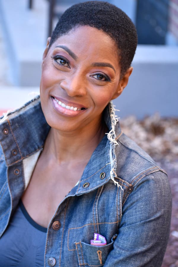 Actress headshot in denim jacket smiling outdoors, NYC by Dorothy Shi