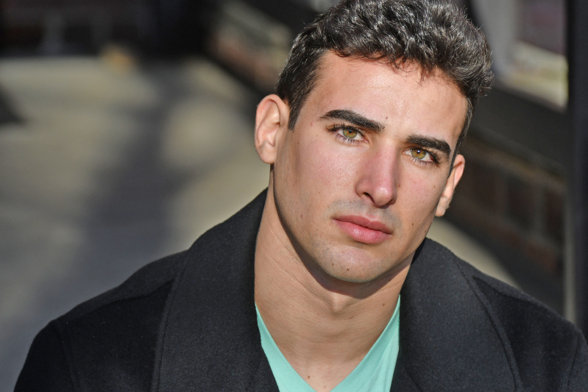 Male actor headshot close-up in dark coat, NYC