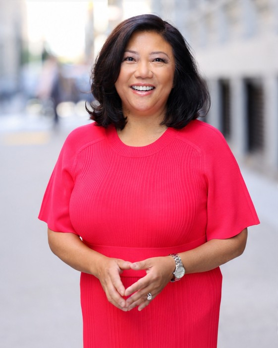 On-location NYC headshot of a woman in a red dress