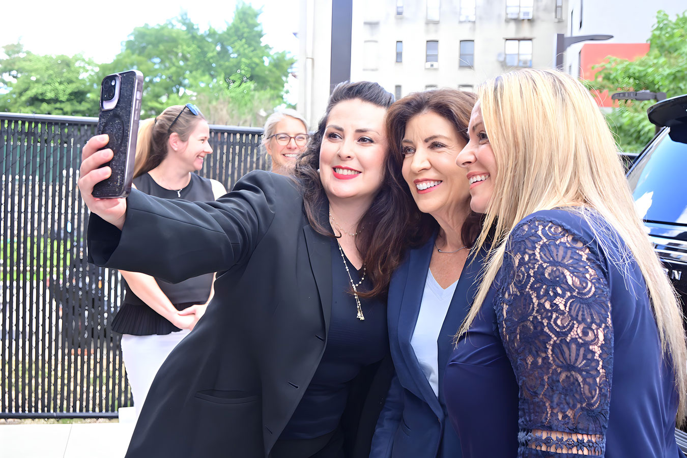 Kathy Hochul at a corporate event selfie moment photographed by Dorothy Shi