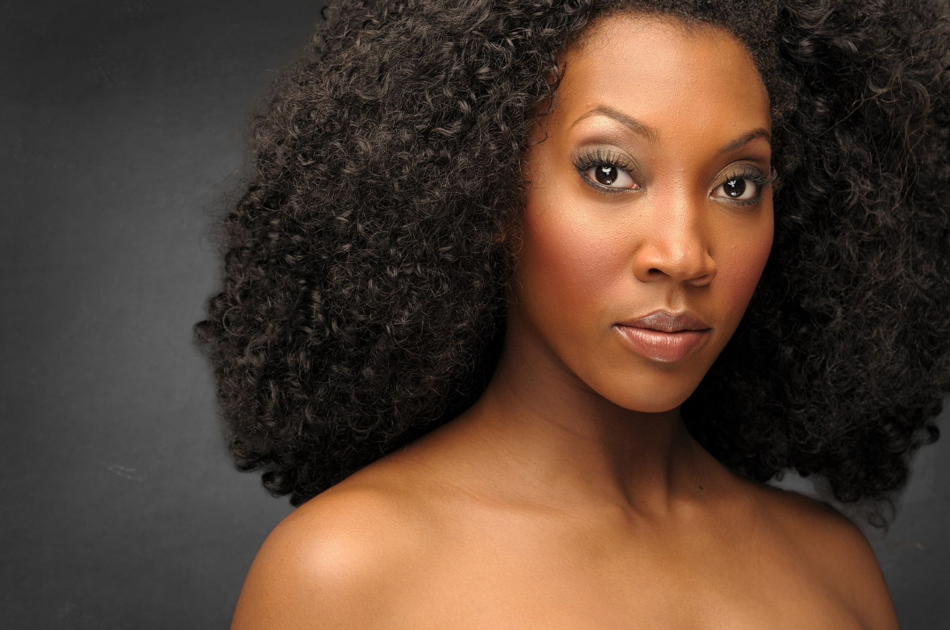 Actress beauty headshot with natural afro on grey backdrop, NYC