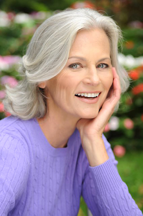 Mature actress headshot with silver hair in purple sweater outdoors, NYC