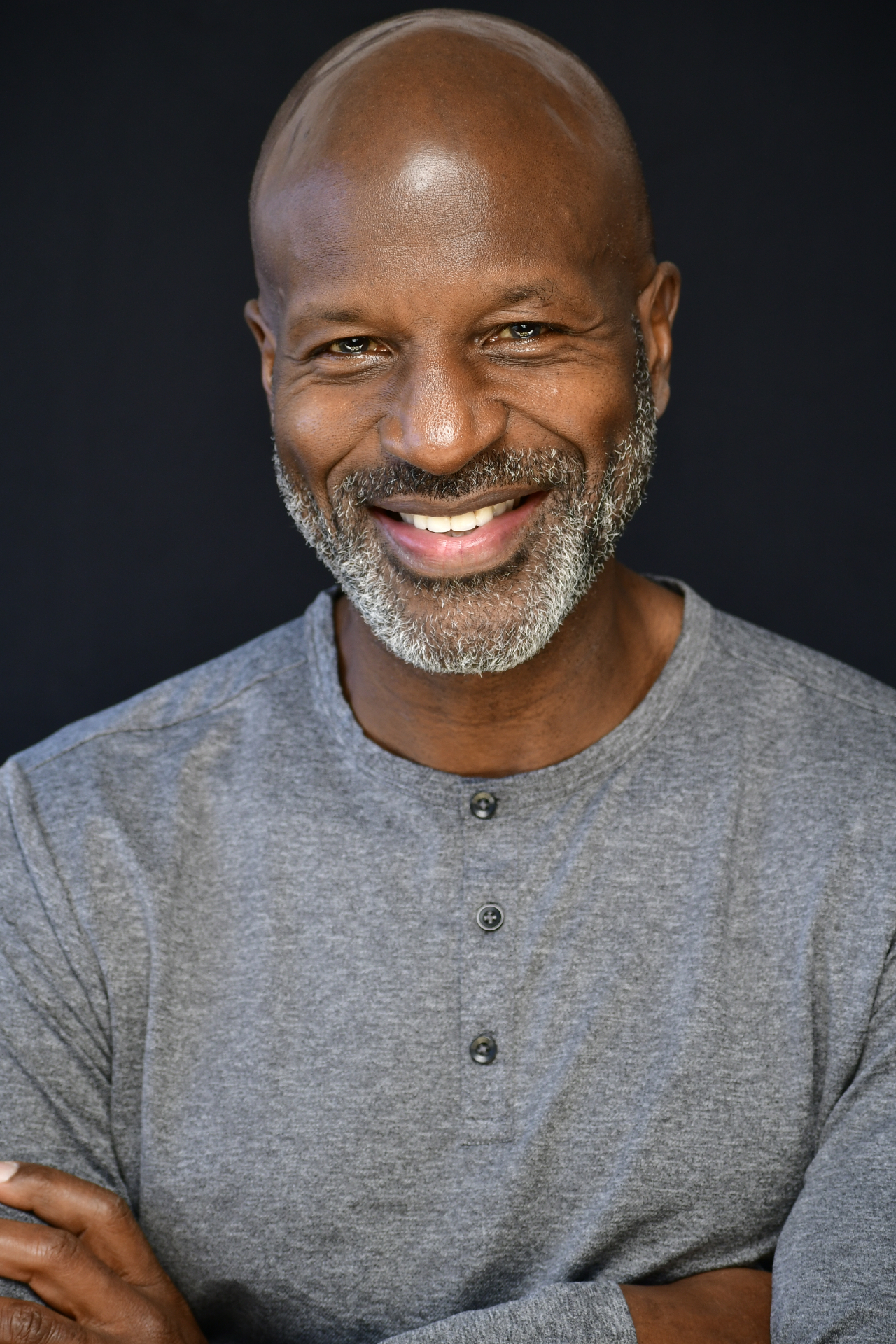 Mature male actor headshot — bald, grey beard, grey henley, NYC by Dorothy Shi