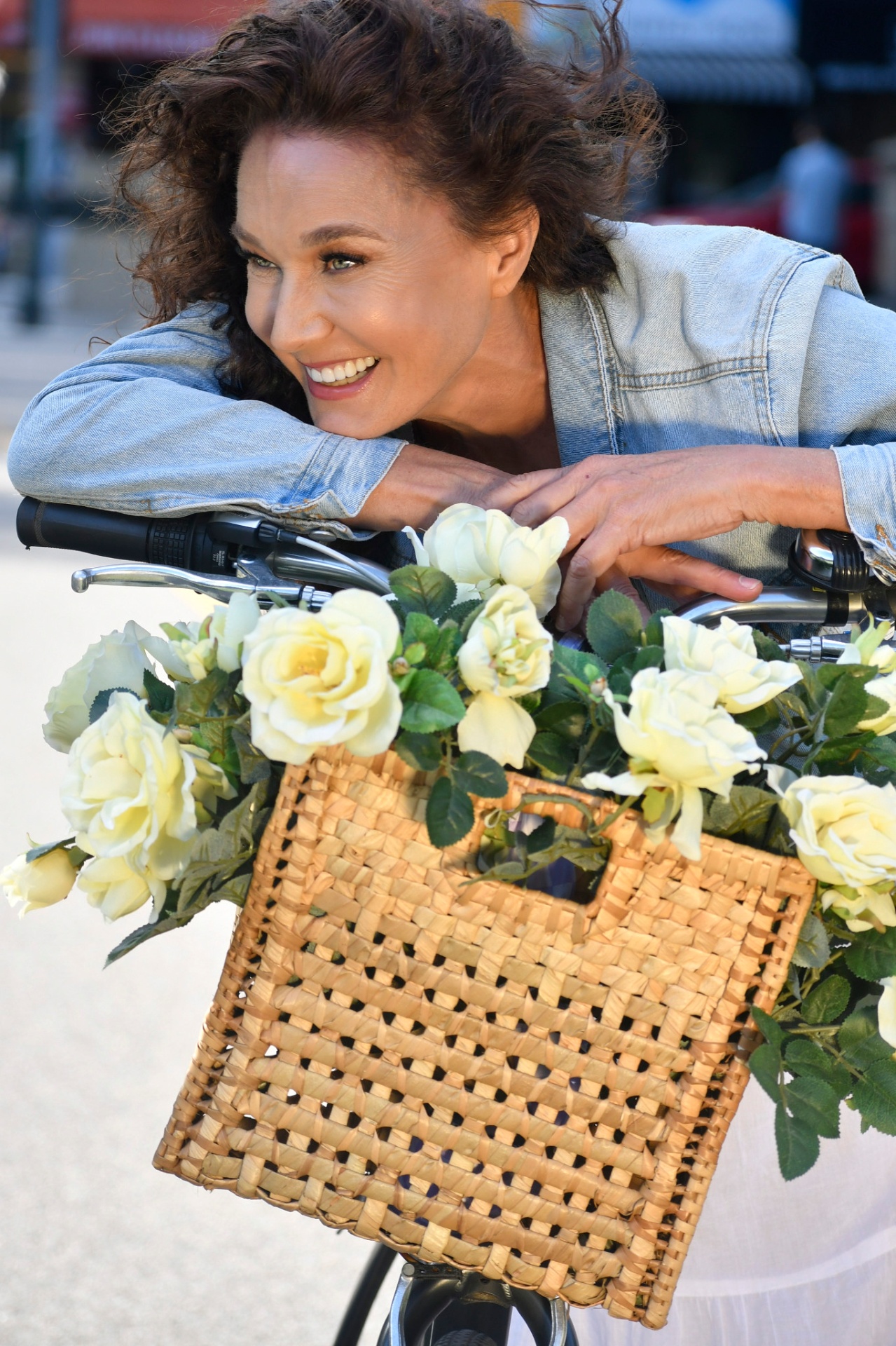 Commercial lifestyle — mature model with bike and flowers, NYC