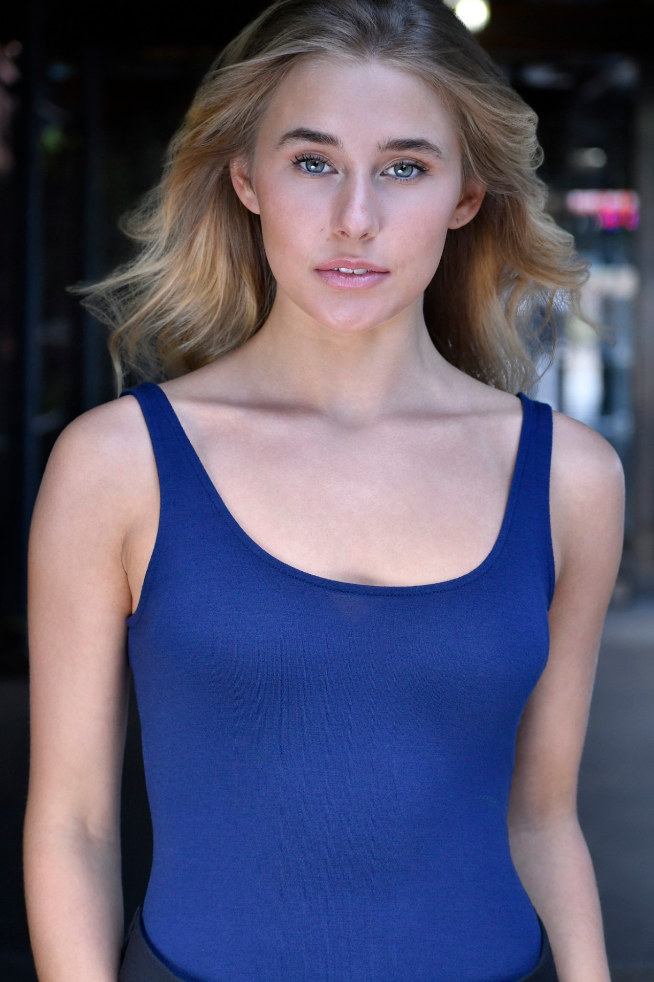 Professional actor headshot of a blonde actress in a blue tank, NYC